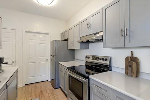 a kitchen with stainless steel appliances and white cabinets
