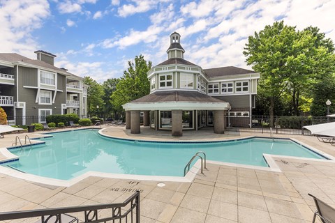 A pool with a building in the background.
