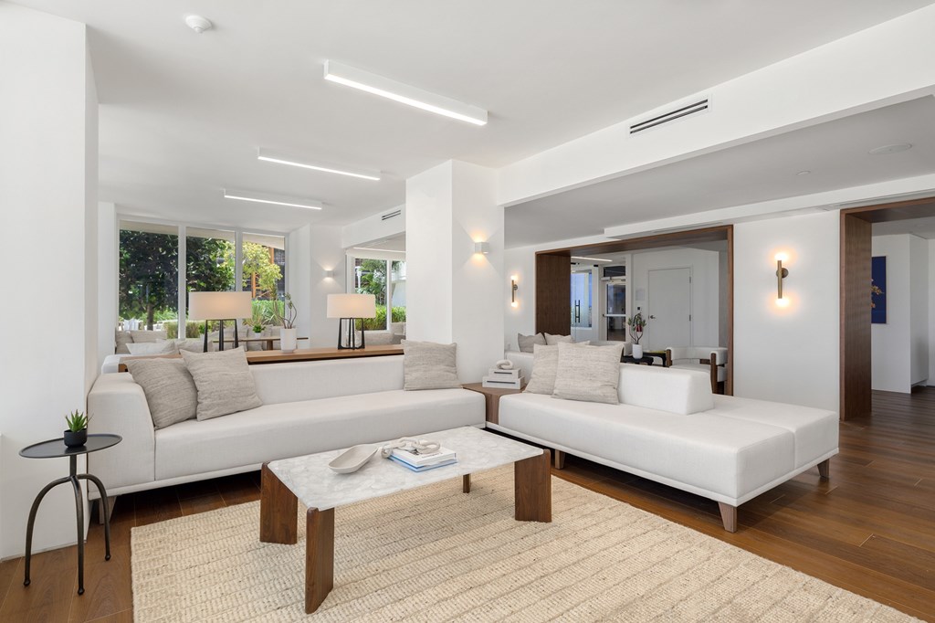 A modern living room with a white sofa and a wooden coffee table.