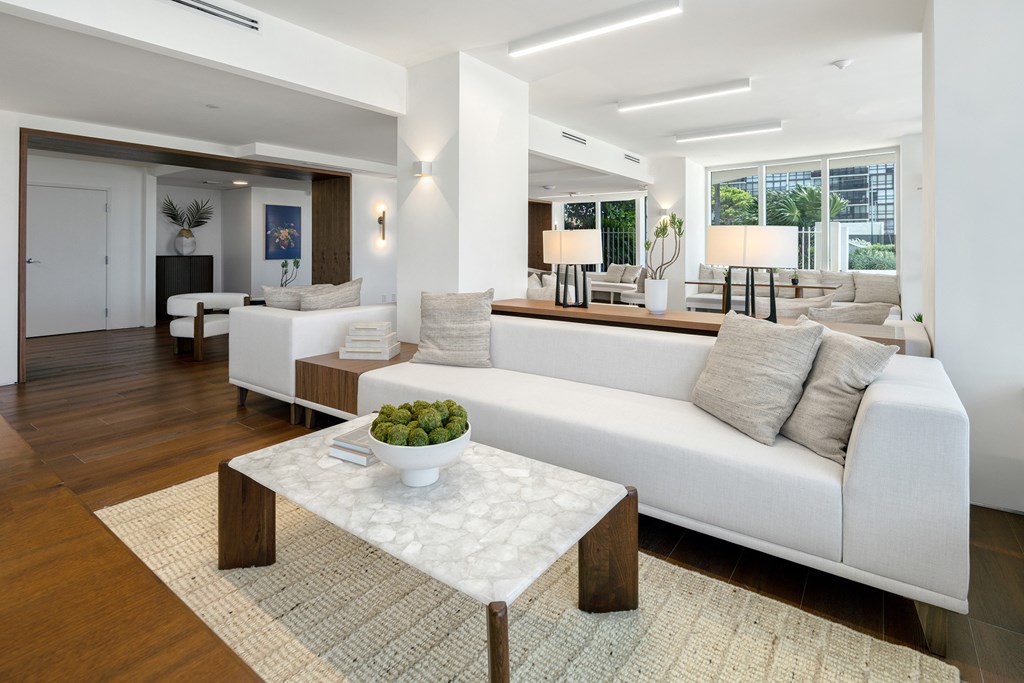 A modern living room with a white sofa and a coffee table.