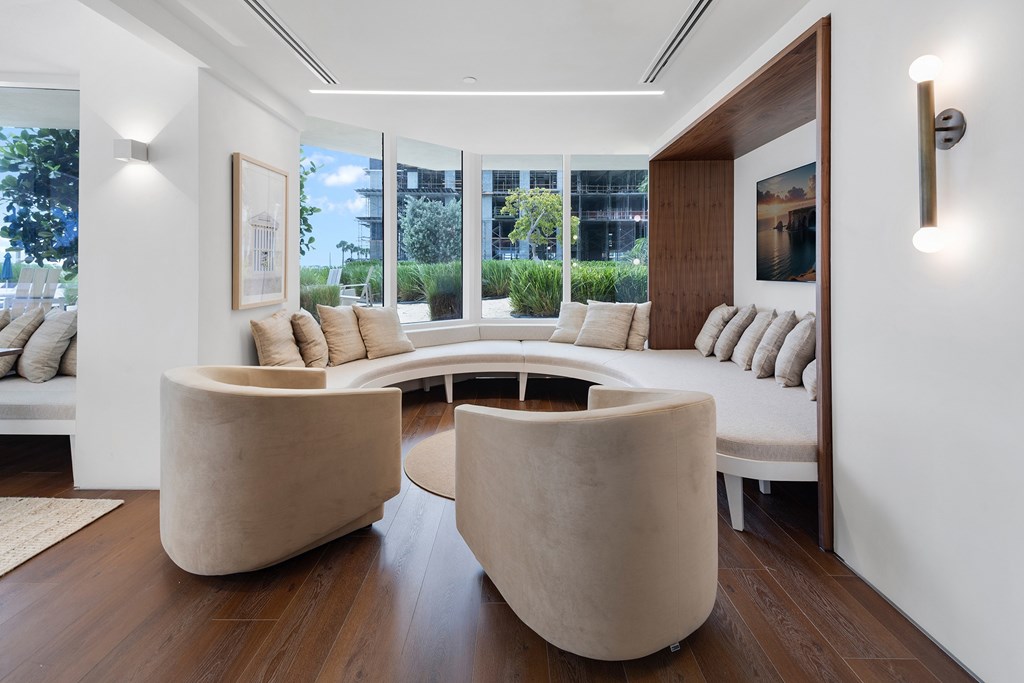 A modern living room with a large window and a view of the city.