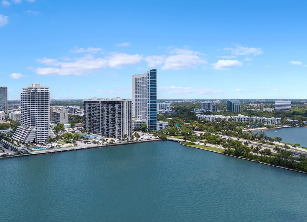 A cityscape with a large body of water in the foreground.