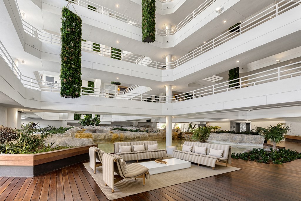 A modern interior with a wooden floor and a living wall.
