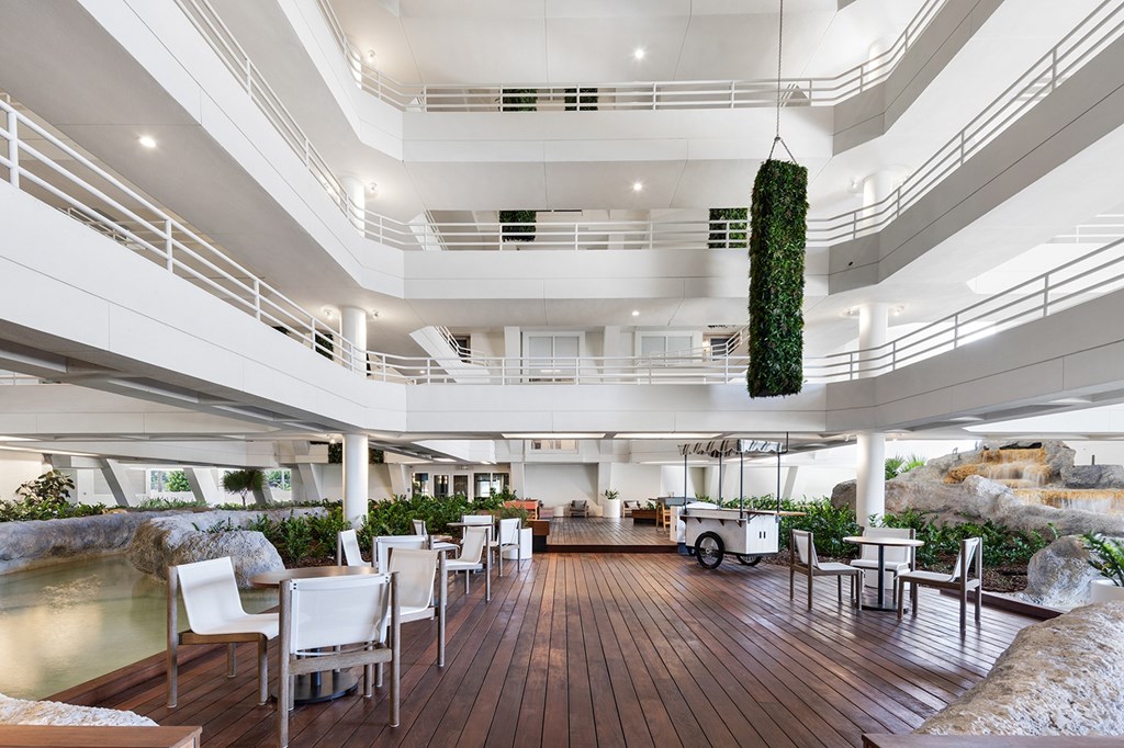A modern interior with a curved wooden floor and white walls.
