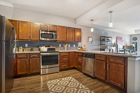 a kitchen with wooden cabinets and stainless steel appliances