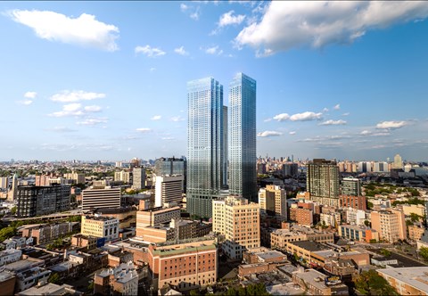 A cityscape with a large blue building in the center.