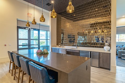 a kitchen with a long island and chairs in front of a counter and a large