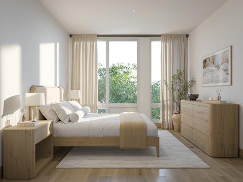 A bedroom with a large bed and a view of trees outside the window.