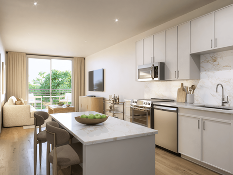 A modern kitchen with a large island and a view of the backyard.
