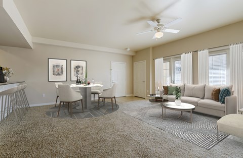 a living room and dining room with a couch and a table