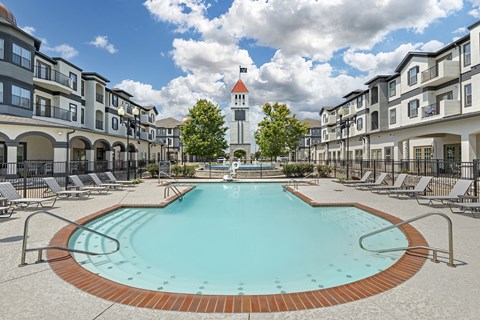 our apartments have a large pool with a church tower in the background at Villaggio Apartments, Louisiana, 71111