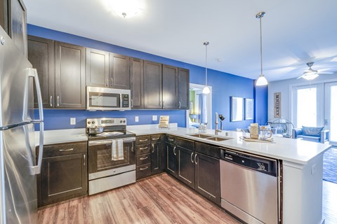 a kitchen with stainless steel appliances and a white counter top