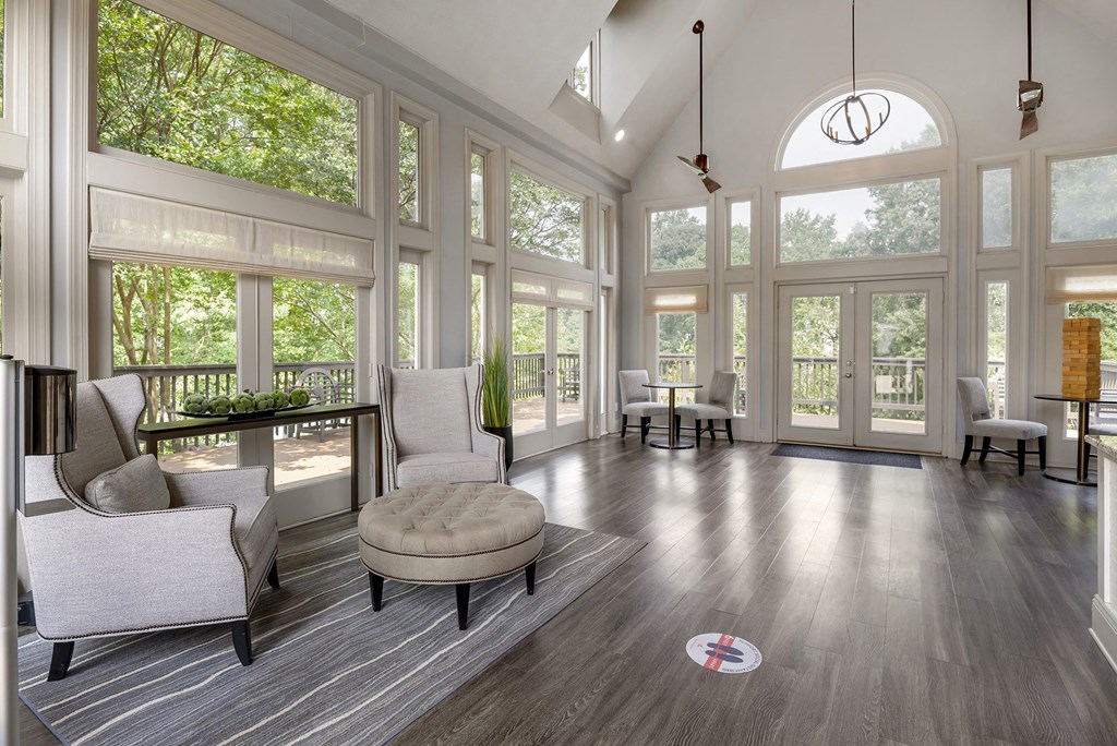 a living room with a large amount of windows and furniture
