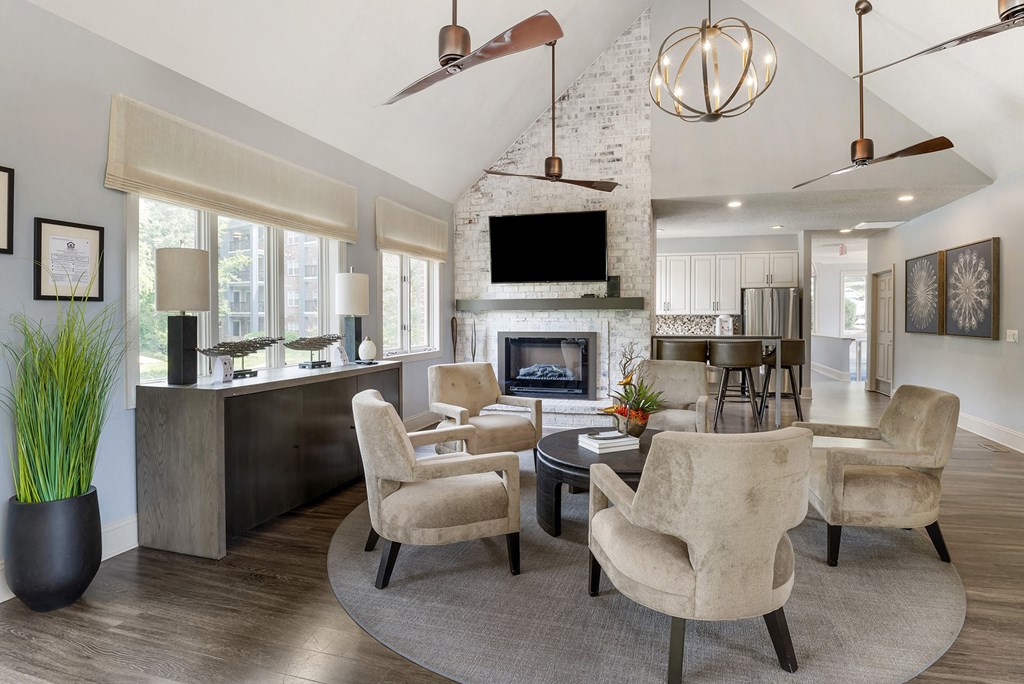 a living room with a fireplace and a table and chairs