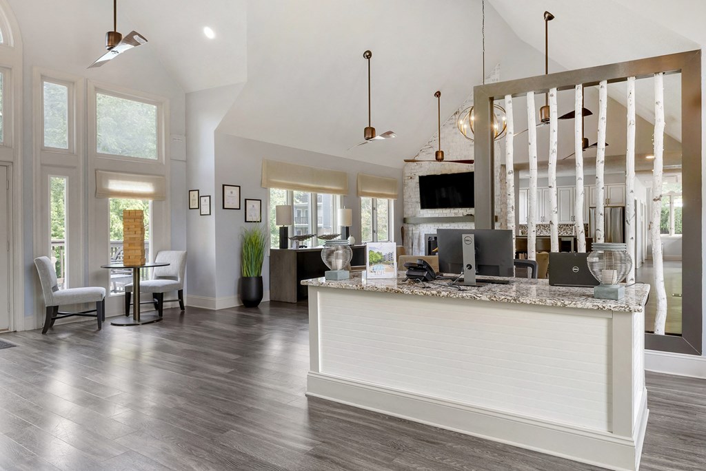 an open concept kitchen and living room with a bar and a table with chairs