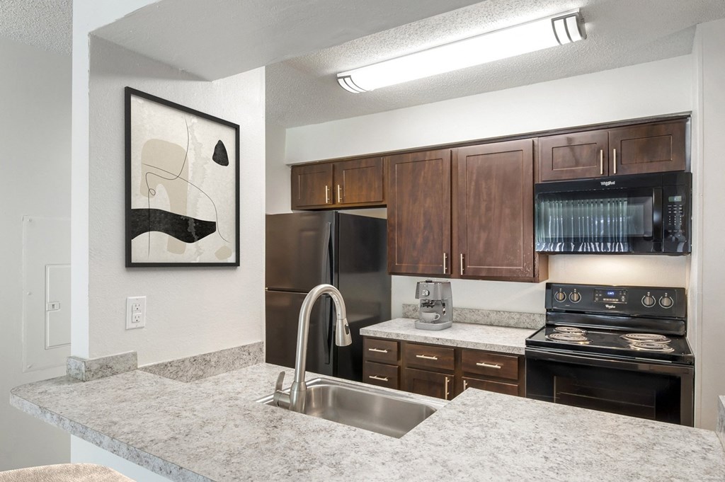 a kitchen with granite counter tops and stainless steel appliances