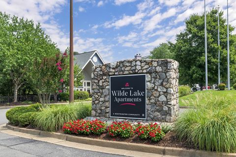 the sign at the entrance of white lake apartments