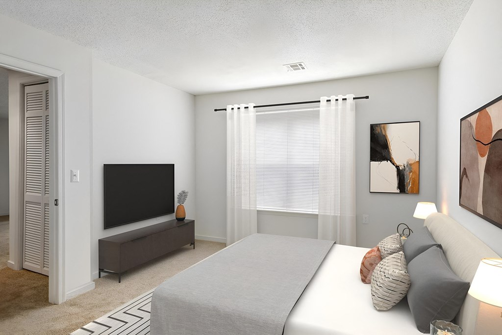 a bedroom with a bed and a tv