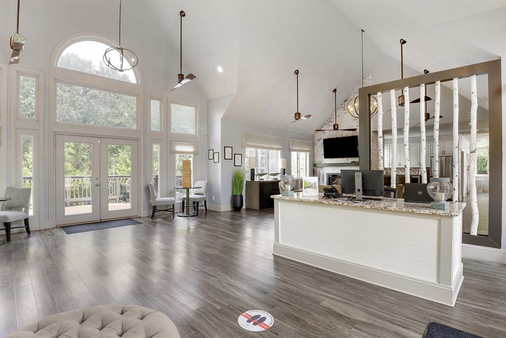 a large living room with a bar and a kitchen