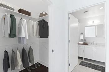 A white bathroom with a white sink and a white cabinet.