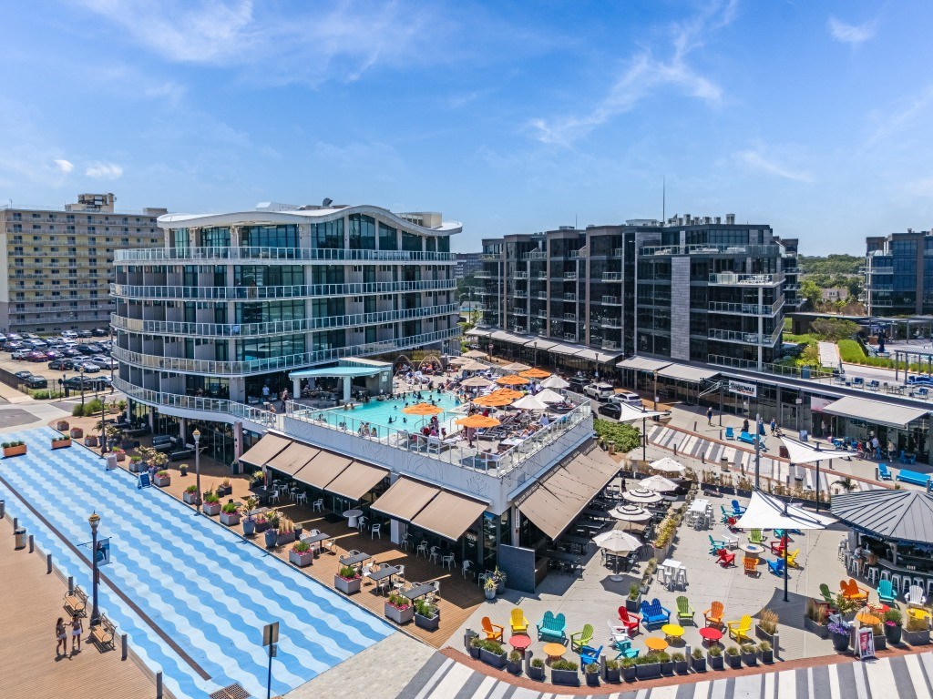 A large outdoor plaza with a pool and seating area.
