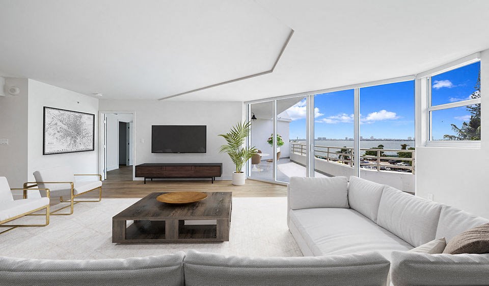 a living room with a white couch and a television at The Hamilton, Miami, FL
