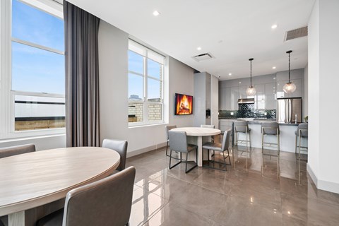 A modern dining room with a large table and chairs. at 65 Bay Street Apartments, Jersey City, 07302