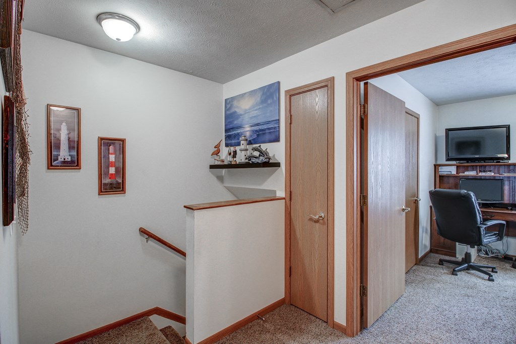 an office with a desk and a chair in a room with a door and a