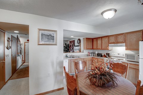 a kitchen and dining area with a wooden table and chairs
