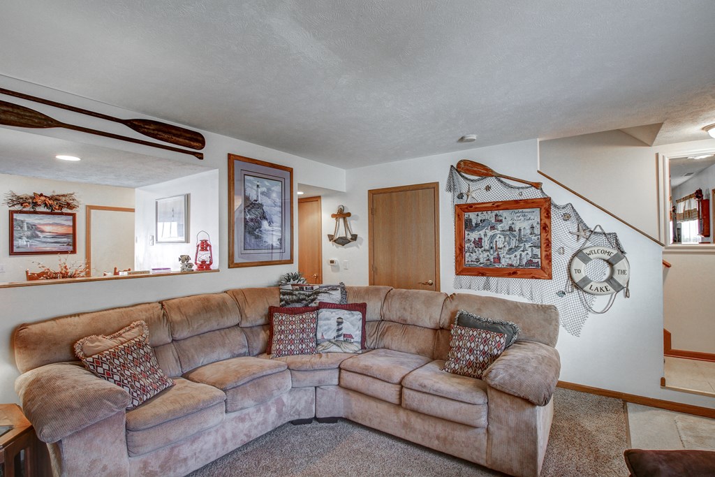 a living room with a large couch and a rug