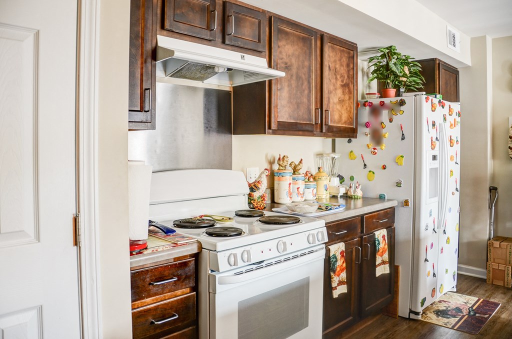 a small kitchen with a white stove and a refrigerator