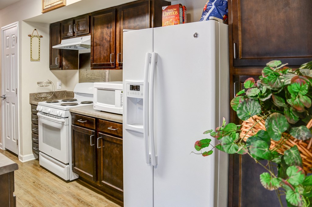 a kitchen with white appliances and a white refrigerator