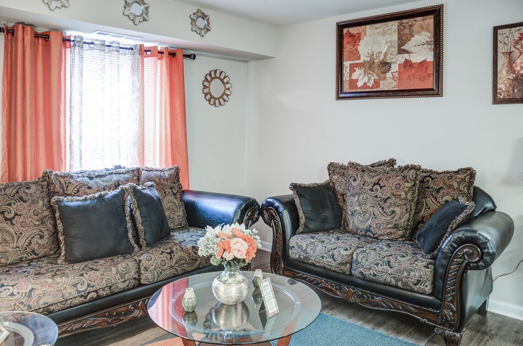 a living room with leather couches and a coffee table