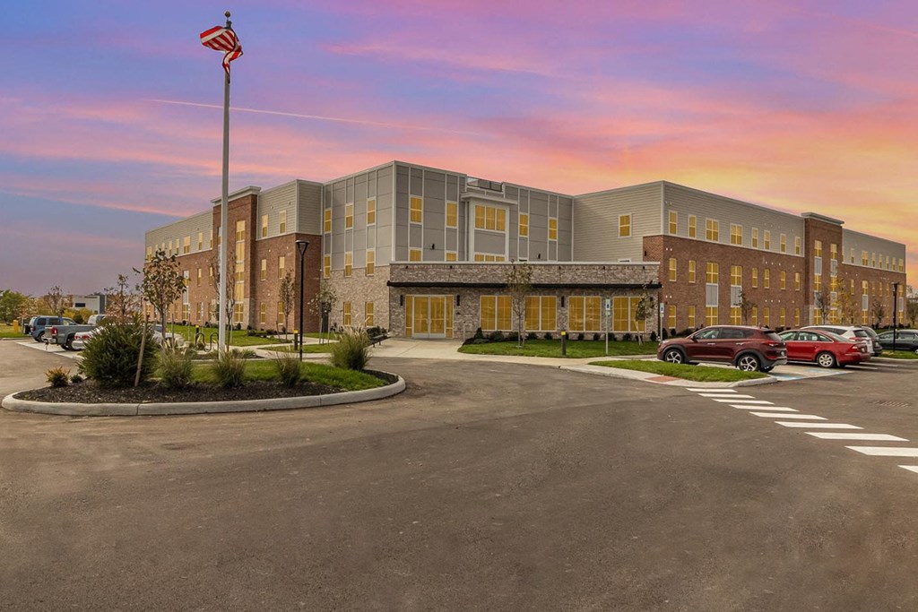 a large building with cars parked in front of it