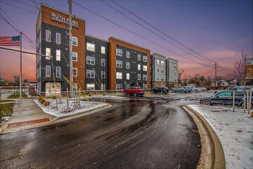 a street with cars parked in front of a building