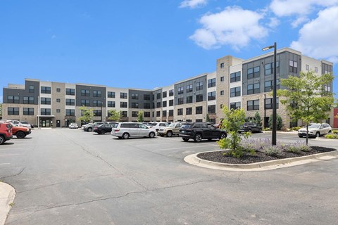 an empty parking lot in front of an apartment building