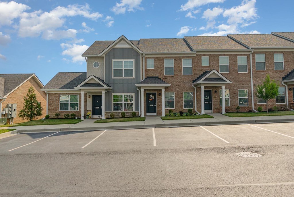 a large brick building with a parking lot in front of it