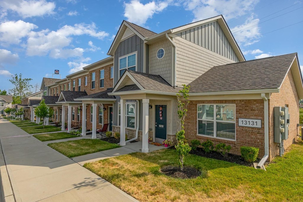 a row of houses with a sidewalk in front of them