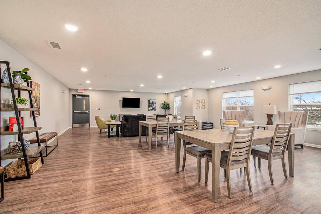 a living room with a dining room table and chairs