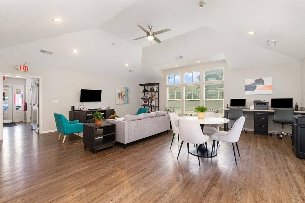 a living room with hardwood floors and a vaulted ceiling