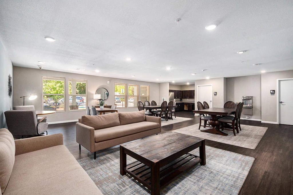 a living room with couches and chairs and a table