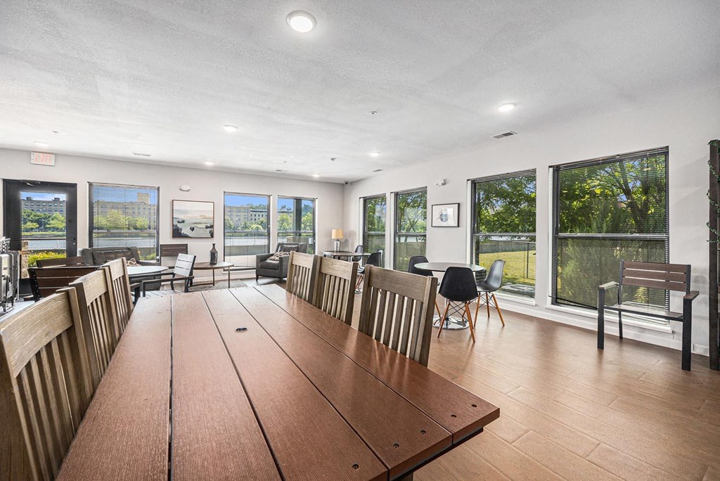 a large dining room with a large wooden table and chairs