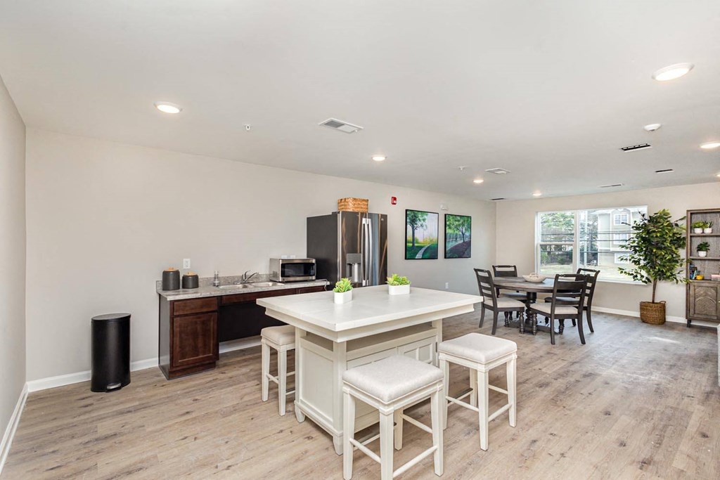 A kitchen with a white table and chairs.