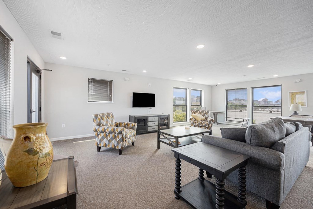 a living room with a couch and chairs and a television