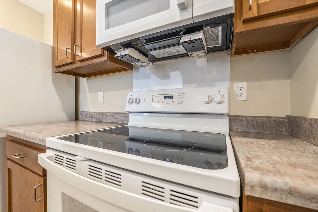 a kitchen with a stove and a microwave