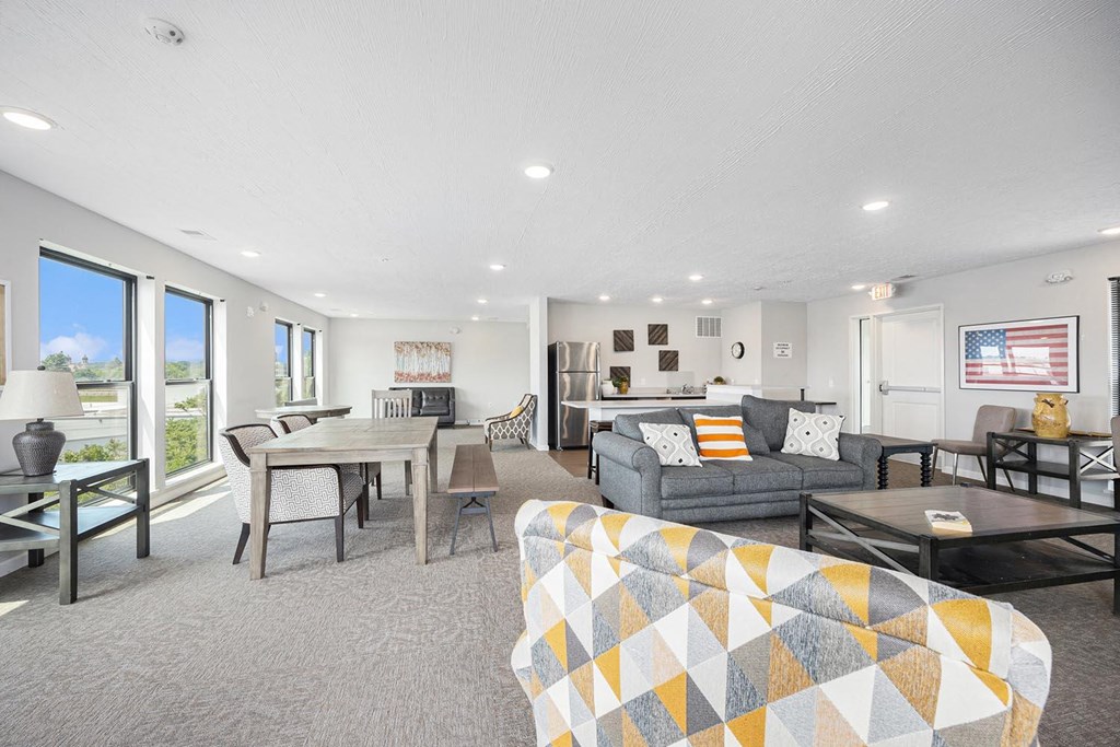 a living room and dining room with a table and chairs