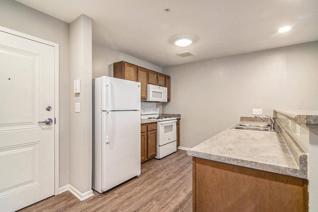a kitchen with white appliances and a counter top