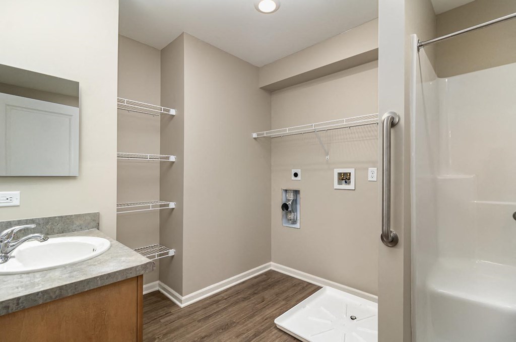 a bathroom with a shower and a sink and a mirror