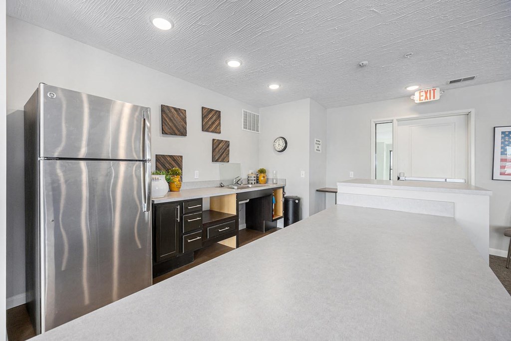 a kitchen with a counter top and a refrigerator