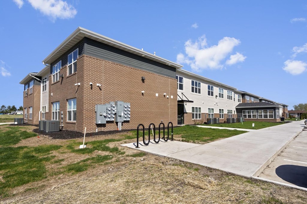 a brick building with a bike rack in front of it